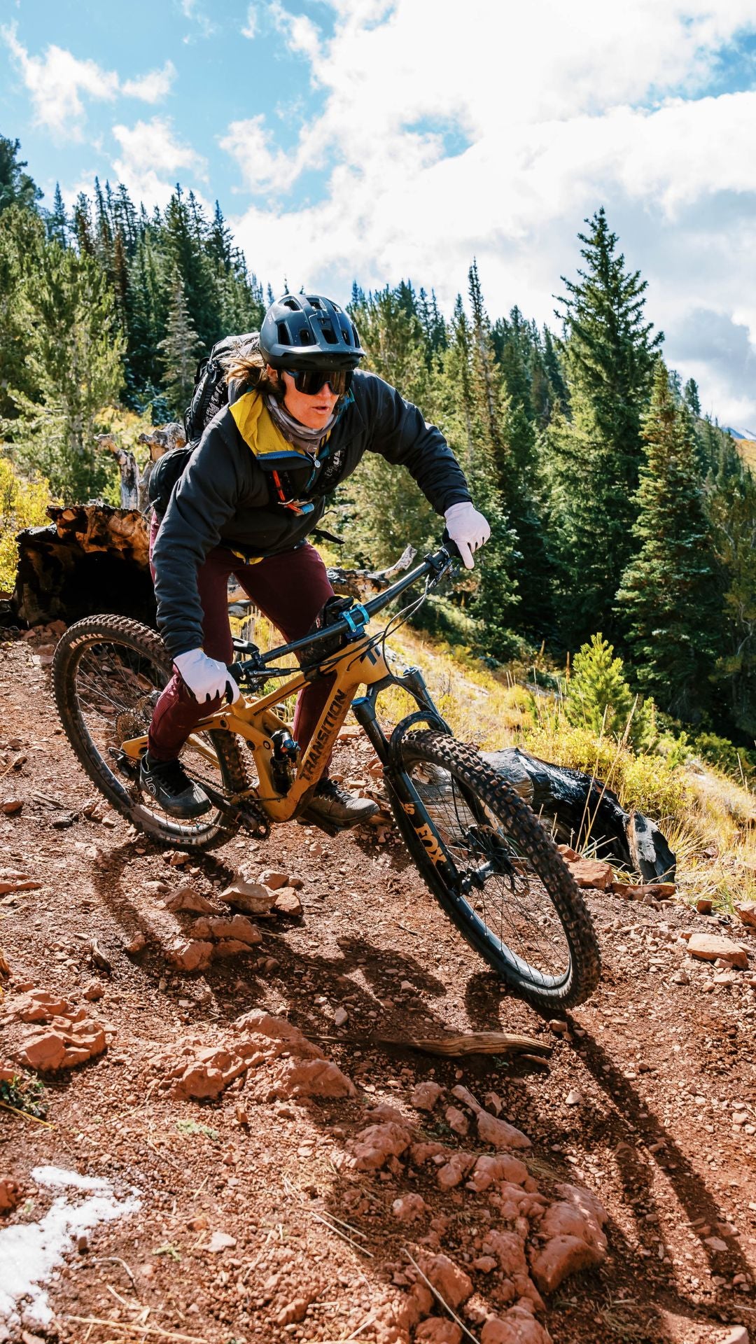 Woman mountain biking around corner in Park City, UT