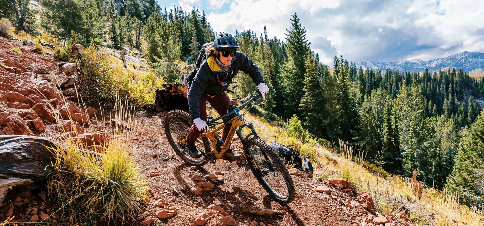 Woman mountain biking around corner in Park City, UT