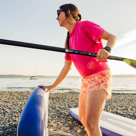 Woman getting ready to stand up paddle board 